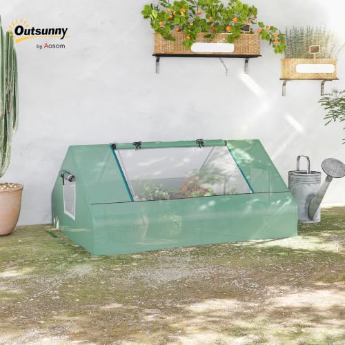 outsunny 71" x 55" x 32" mini greenhouse shown in use