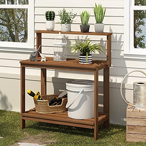 furinno tioman outdoor potting bench with storage shelf shown in use